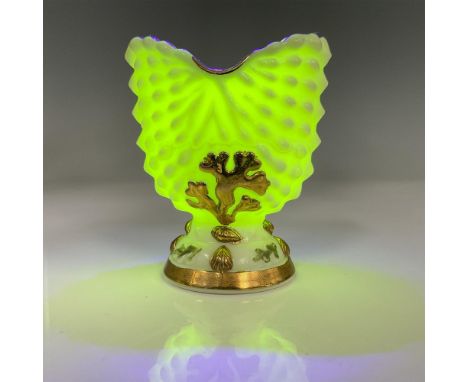 Opaque glass with a dot pattern, gold embellishments, and artist signature on the base. Fluoresces under black light. Issued: