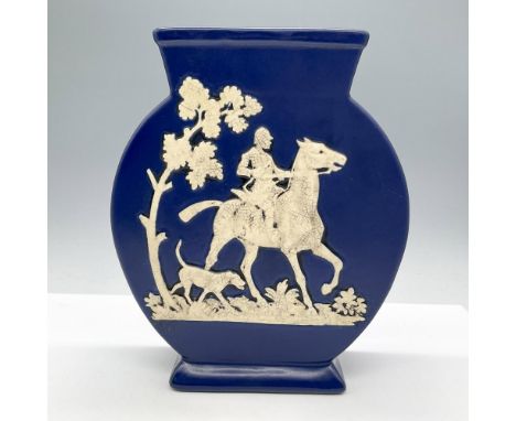 Features a rich deep blue color, adorned with a white bas-relief hunting scene depicting a rider on horseback accompanied by 