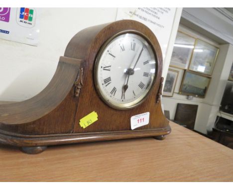 SMALL NAPOLEON STRIKING MANTLE CLOCK IN WOODEN CASE.