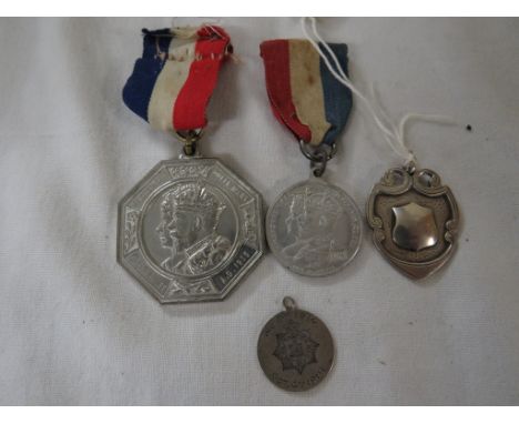 George V commemorative medal, one other commemorative medal, white metal Army Cyclist Corp pendant dated 1915, and a silver m