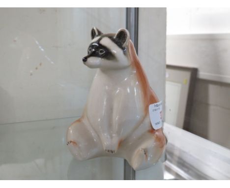 CERAMIC FIGURE OF A SEATED RACOON MARKED MADE IN THE USSR.