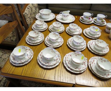 PORCELAIN TEA WARE PAINTED WITH ROSES, TOGETHER WITH A SMALL QUANTITY OF ROYAL SUTHERLAND TEA CUPS AND SAUCERS