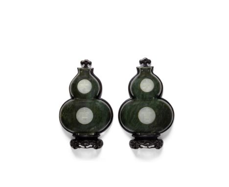 A pair of spinach jade 'double-gourd' wall hangings inlaid with white jade plaquesLate Qing/Republic PeriodIdentically design