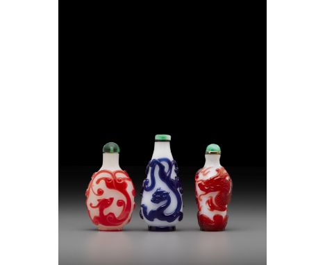 Three overlay decorated glass 'dragon' snuff bottlesLate 18th/19th centuryIncluding two red overlay bottles: one decorated wi