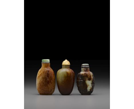 Three russet jade snuff bottlesLate 19th/20th centuryEach well-hollowed; the first with gently sloping shoulders, the matrix 