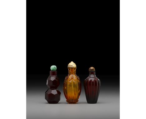 Three glass snuff bottles18th/19th century The first a ruby-red double-gourd bottle with faceted sides, with a wide mouth, th