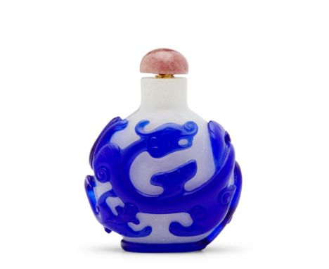 TWO BLUE OVERLAY GLASS SNUFF BOTTLES1750-1850The blue layer on the first carved to form three  sinuous chilong wrapping aroun