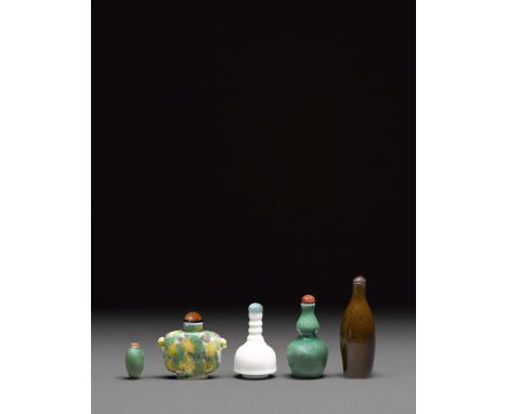 Five porcelain snuff bottles19th centuryComprising a three-color glazed square-form bottle surmounted with a pair of faux lio