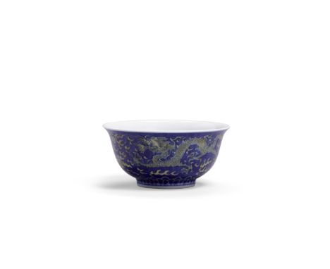 An underglaze blue and yellow enameled dragon bowlKangxi six-character mark and of the periodElegantly potted with two five-c