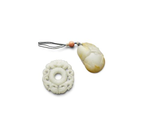 Two jade pendantsThe first of circular shape, pale greenish-white hue, and undercut with facing dragons and a bat surrounding