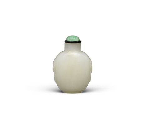 A carved white jade snuff bottle19th/early 20th centuryThe well-hollowed bottle of ovoid profile, standing on a rounded oval 
