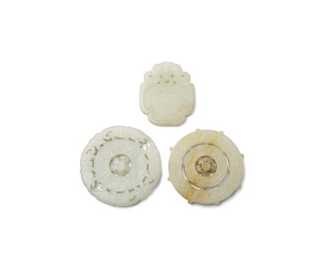 Three jade plaquesLate Qing/Republic periodIncluding two circular bi discs each with a mobile central flower-head: one design