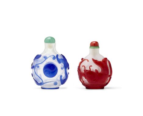 TWO OVERLAY GLASS SNUFF BOTTLEs1730-1850The first with blue overlay carved to form a taiji symbol centering each main side, f