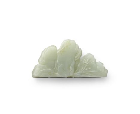 A carved jade brush rest18th/19th centuryThe thinly sectioned stone carved to all surfaces as a craggy multi-peaked mountain,