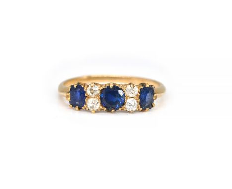 A GOLD, SAPPHIRE AND DIAMOND RINGClaw set with three sapphires alternating with two pairs of cushion shaped diamonds, ring si