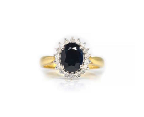 AN 18CT GOLD, SAPPHIRE AND DIAMOND OVAL CLUSTER RINGClaw set with the oval cut sapphire, in a surround of circular cut diamon