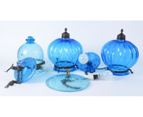 A PAIR OF BRASS MOUNTED BLUE GLASS ‘HUNDI’ PENDANT LAMPS AND ANOTHER WITH ENGRAVED DECORATIONLate 20th Century Each with a si