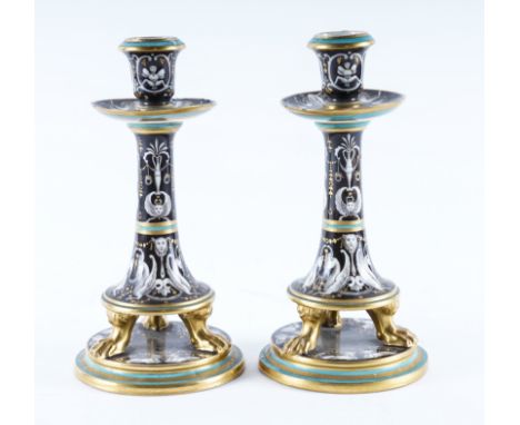 A PAIR OF UNUSUAL VIENNA PORCELAIN CANDLESTICKS (2)19th centuryOf inverted trumpet form, each raised on three gilt paw feet a