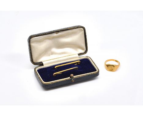 A GOLD SIGNET RING AND TWO GOLD PLAIN BAR BROOCHES (3)The signet ring crest engraved, detailed 18 CT, ring size N, weight 6.1