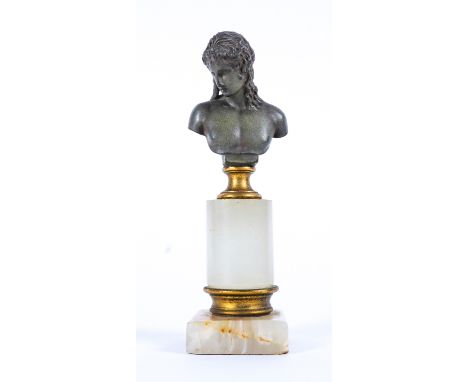 AN ITALIAN BRONZE BUST MOUNTED ON A GILT-METAL MOUNTED ONYX PEDESTALAfter the AntiqueThe green patinated bust on gilt socle, 