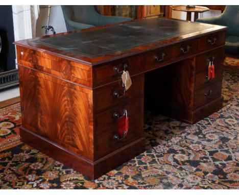 A MAHOGANY EIGHT DRAWER PEDESTAL DESKWith green leather inset top, 168cm wide; 84cm deep **This lot is subject to 20% VAT on 