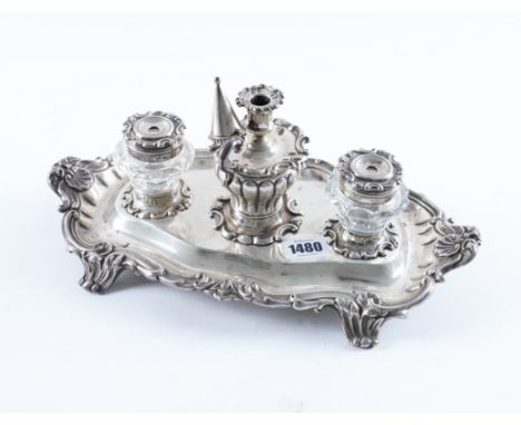 AN EARLY VICTORIAN SILVER TWIN BOTTLE INKSTANDOf shaped oval form, decorated with a scalloped and scrolled border, raised on 