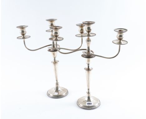 A PAIR OF SILVER TABLE CANDLESTICKS WITH ASSOCIATED SILVER THREE LIGHT CANDELABRA BRANCHES (2)Each candlestick with a tapered