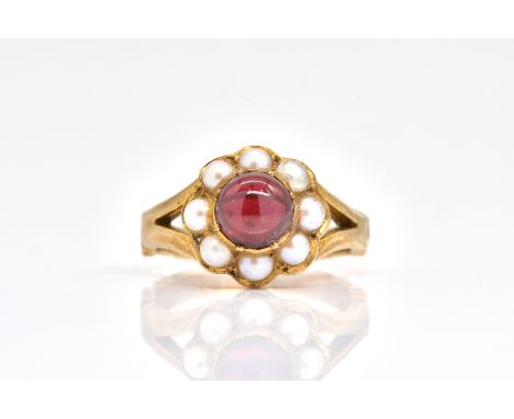 A 9CT GOLD, CARBUNCLE GARNET AND CULTURED PEARL CLUSTER RINGMounted with the carbuncle garnet at the centre, within a surroun