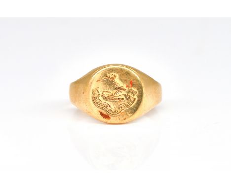 A GOLD SIGNET RINGCrest and motto seal engraved, detailed indistinctly 18 CT, ring size P and a half, weight 6.8 gms