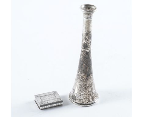 A SILVER PILL BOX AND A SILVER PEPPERETTE (2)The pill box designed as a miniature book, the exterior engraved, 'When this you