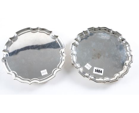 A SILVER WAITER AND TWO PLATED ITEMS (3)The silver waiter of shaped circular form, having a pie-crust rim, raised on three sc