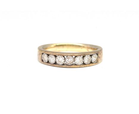 A 9CT GOLD AND DIAMOND SEVEN STONE HALF HOOP RINGMounted with a row of circular cut diamonds, ring size  M, gross weight 3.5 