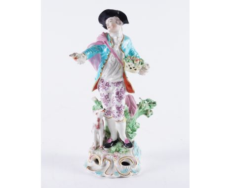 A DERBY FIGURE OF A DRESDEN SHEPHERDCirca 1770Modelled as a young man standing before a tree stump holding a basket of fruit 