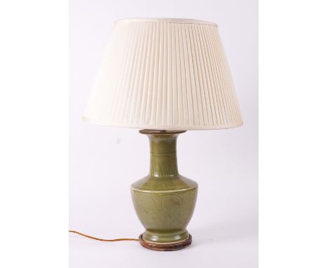 A CHINESE CELADON GLAZED CERAMIC BALUSTER TABLE LAMPModernWith inscribed lotus leaf and scroll decoration, 30.5cm (excluding 