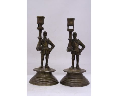A PAIR OF FRENCH BRASS MEDIEVAL PAW GUARD CANDLESTICK HOLDERS