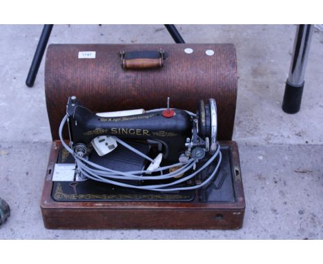 A VINTAGE SINGER SEWING MACHINE WITH WOODEN CARRY CASE