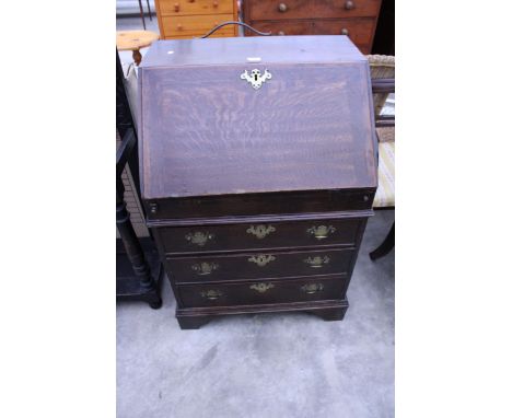 AN OAK GEORGE III BUREAU OF SMALL PROPORTIONS WITH FITTED INTERIOR, THREE GRADUATED DRAWERS TO BASE ON BRACKET FEET, 28" WIDE
