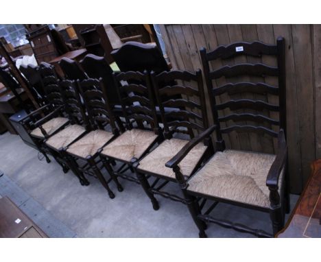 A SET OF SIX LADDER BACK RUSH SEATER DINING CHAIRS, TWO BEING CARVERS