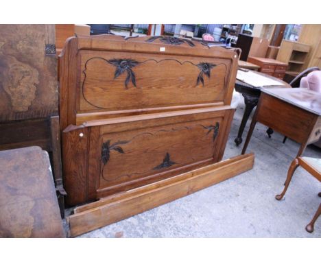 A CONTINENTAL OAK 5' BEDSTEAD WITH FOLIATE CARVING