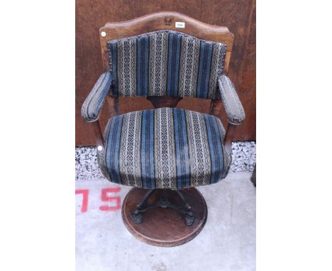 A 19TH CENTURY SWIVEL DESK CHAIR ON TRIPOD CAST IRON BASE WITH UPHOSTERED SEAT, BACK AND ARMS