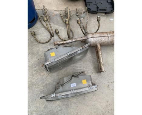 TWO CAR HEAD LIGHTS AND AN EXHAUST PIPE