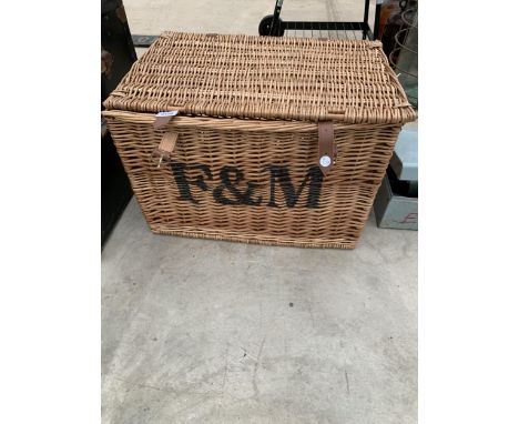 A FORTNUM AND MASON HAMPER BASKET WITH SIDE HANDLES AND LEATHER STRAPS