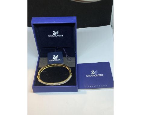 A SWAROVSKI CRYSTAL BANGLE, BOXED WITH TAGS AND CERTIFICATE