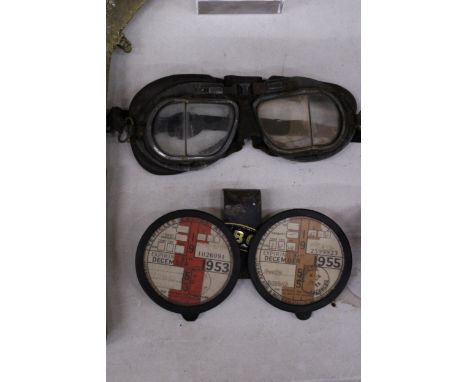 TWO VINTAGE MOTORING TAX DISCS IN A METAL HOLDER PLUS A PAIR OF MOTORCYCLE GOGGLES