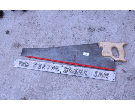 A VINTAGE WOODEN HANDLED HAND SAW AND A FURTHER METAL GARDEN PUB SIGN