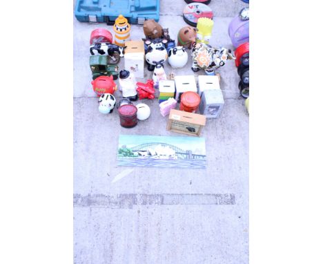 AN ASSORTMENT OF NOVELTY MONEY BOXES AND A TILE
