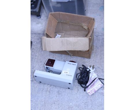 A SINGER MAGIC TAILOR ELECTRIC SEWING MACHINE