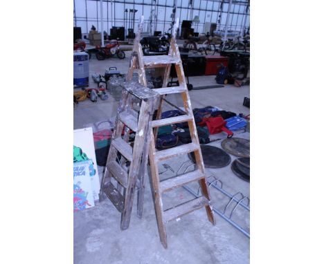 A VINTAGE FIVE RUNG WOODEN STEP LADDER AND A FURTHER FOUR RUNG WOODEN STEP LADDER