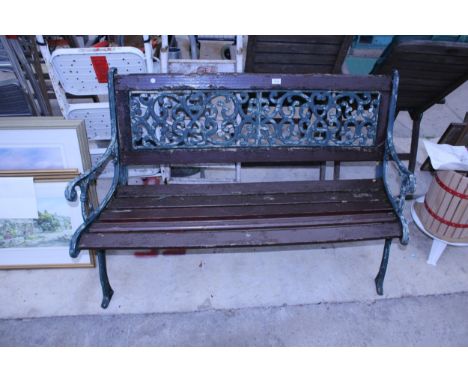 A WOODEN SLATTED GARDEN BENCH WITH CAST ENDS AND BACK