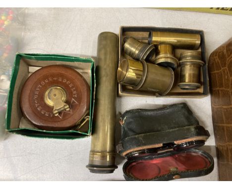 A PAIR OF OPERA GLASSES, AN ADJUSTABLE TELESCOPE, VARIOUS BRASS LENSES AND A VINTAGE MEASURING TAPE
